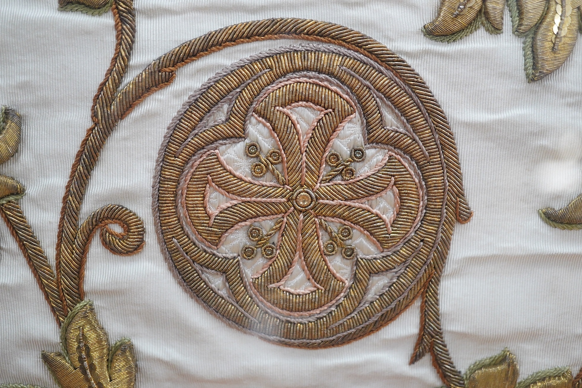 A framed Continental late 18th / 19th century heavily embroidered and deeply couched gold thread and white silk Orphrey panel, possibly part of a Chasuble or similar ecclesiastical garment, 18cm wide x 124cm long. Condit